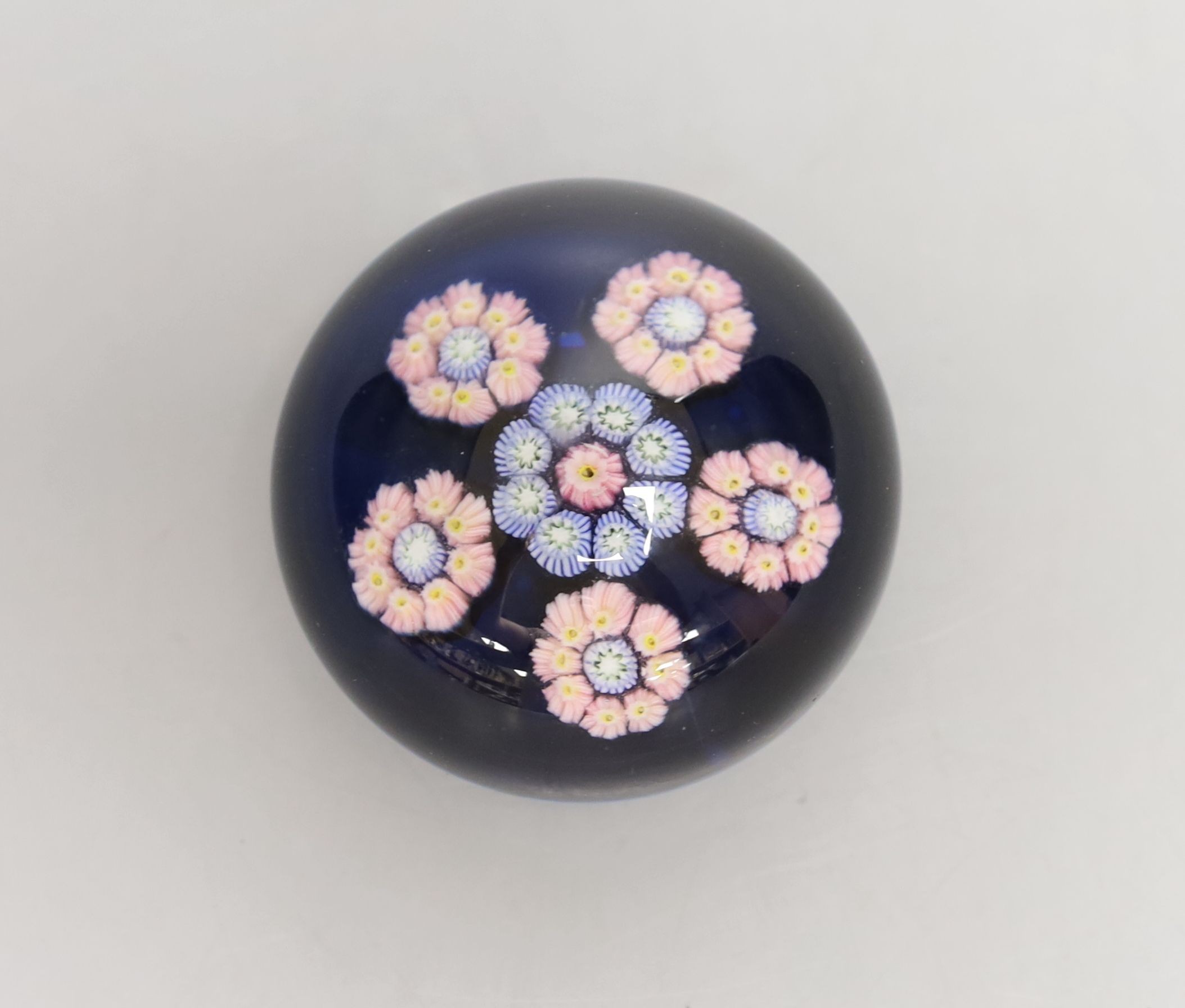 A small Perthshire blue ground millefiori glass paperweight - 6cm diameter